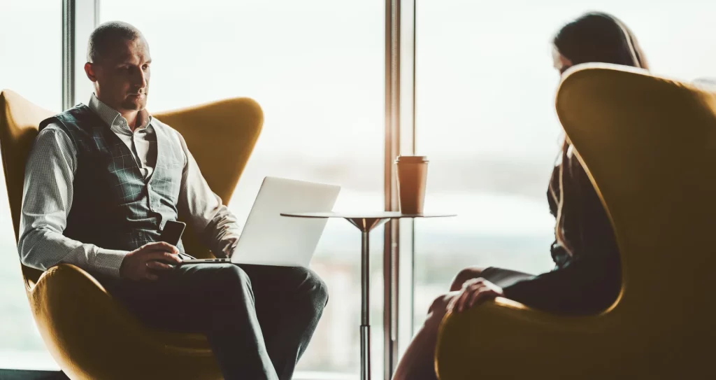 two people sat in chairs discussing return on investments