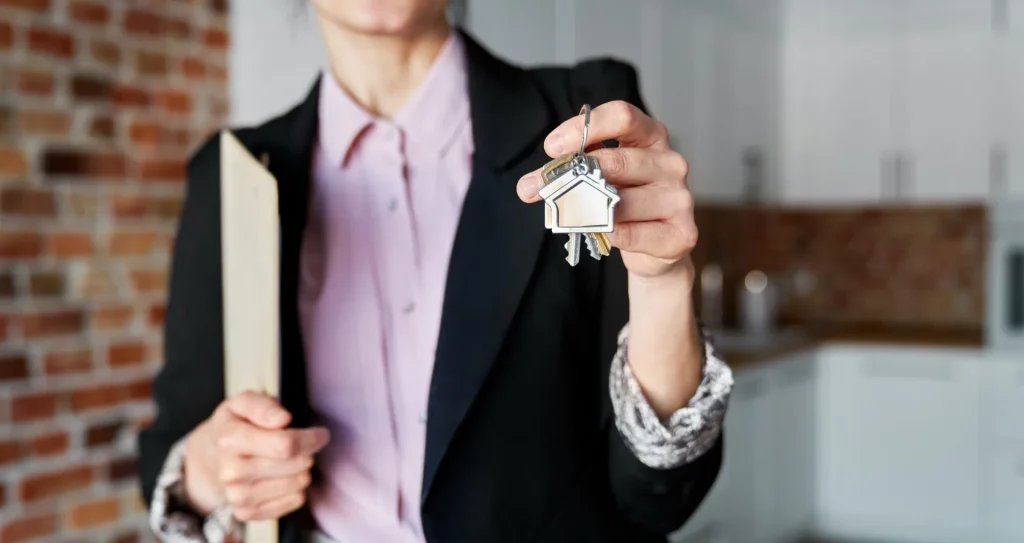 estate agent handing over keys for investment property