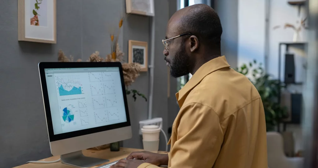 man sat at computer calculating return on investment