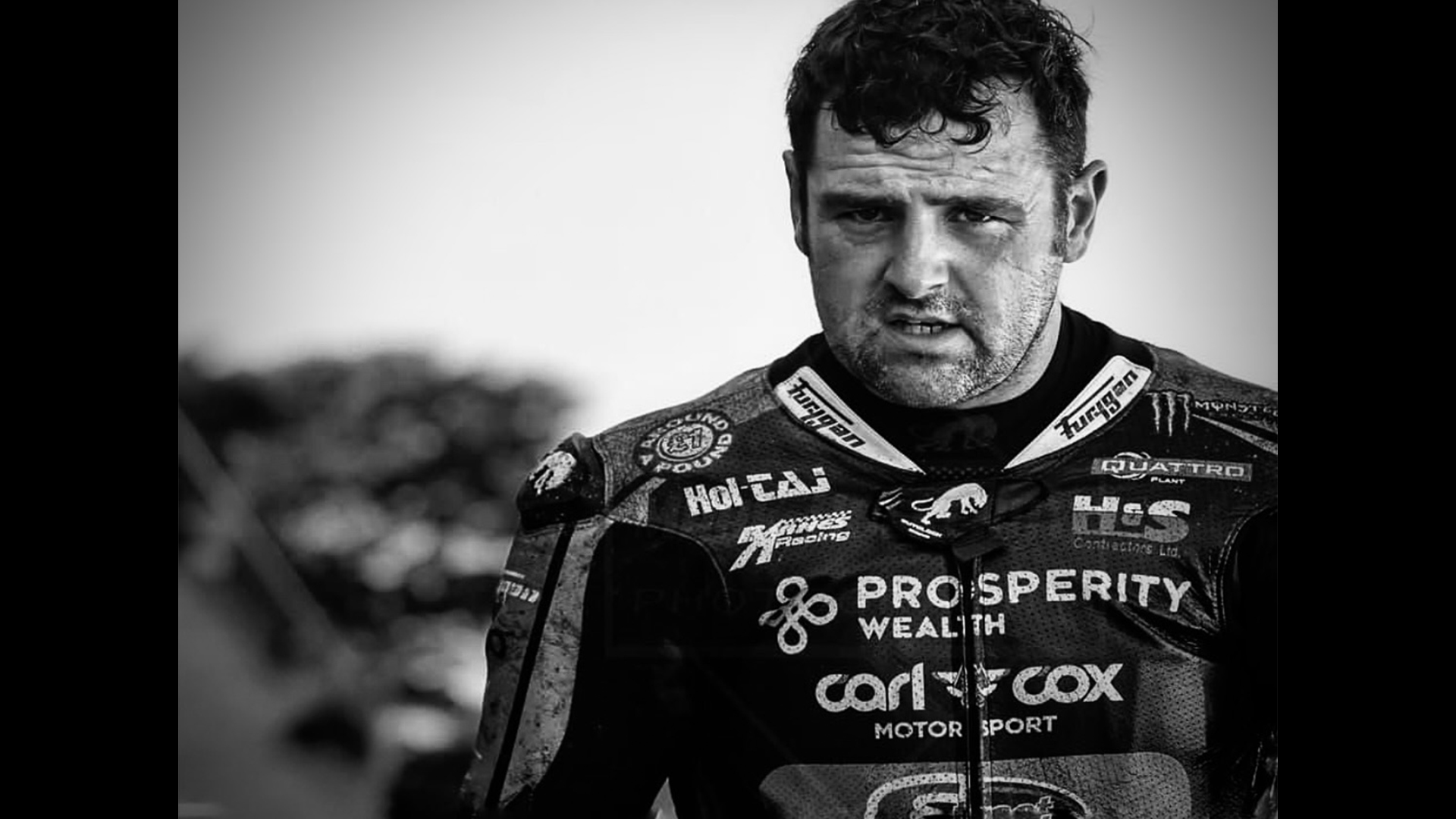 Photo of Michael Dunlop wearing motorbike jacket featuring Prosperity Wealth logo