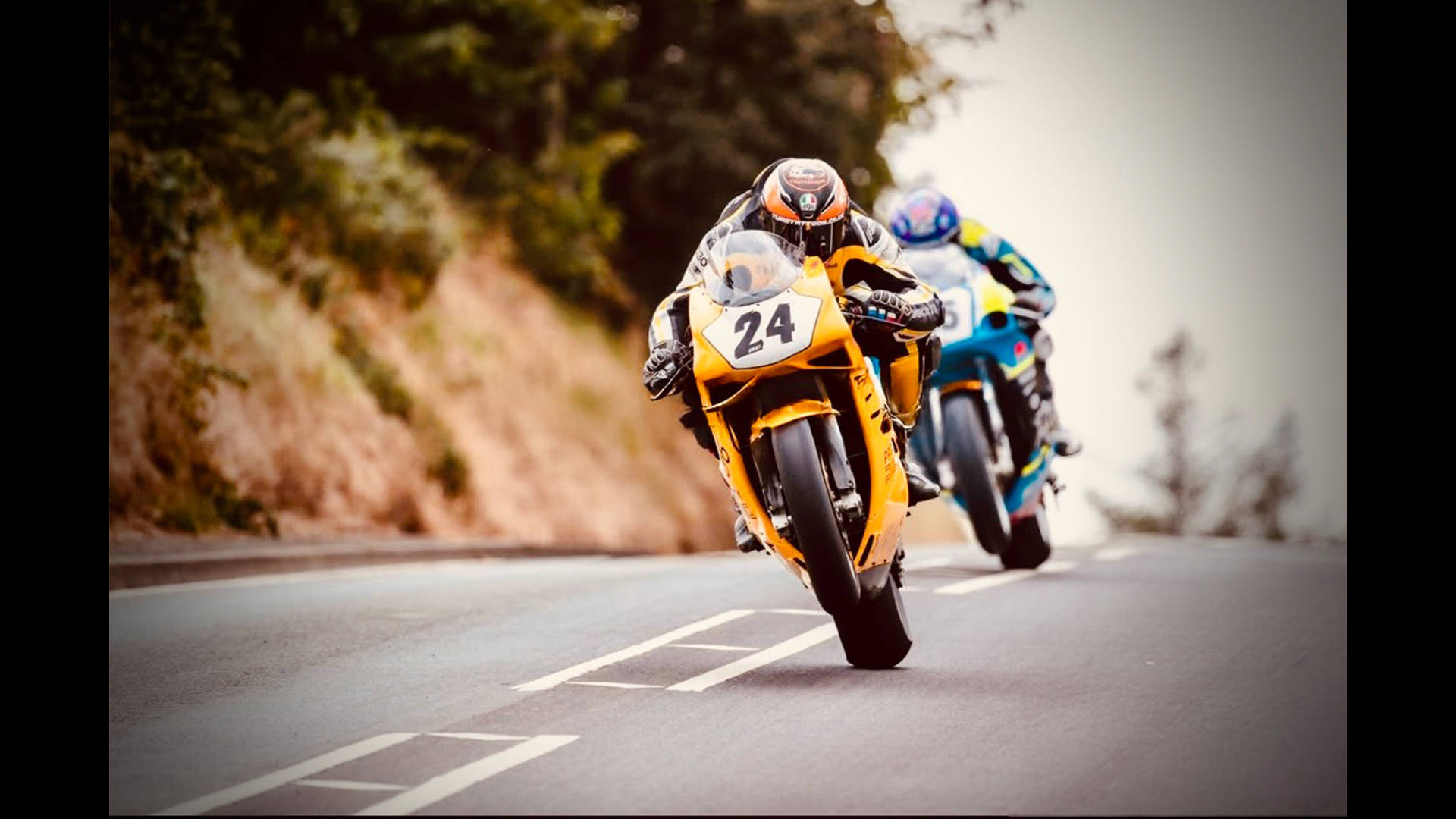 Two motorbikes racing in the road